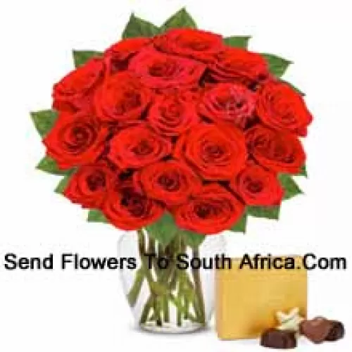 24 Red Roses With Some Ferns In A Glass Vase Accompanied With An Imported Box Of Chocolates