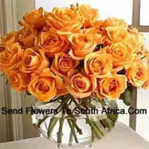 24 Orange Roses With Some Ferns In A Glass Vase