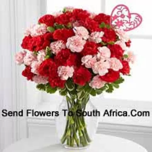 36 Carnations ( 18 Red And 18 Pink ) With Seasonal Fillers And Valentine Heart Stick In A Glass Vase