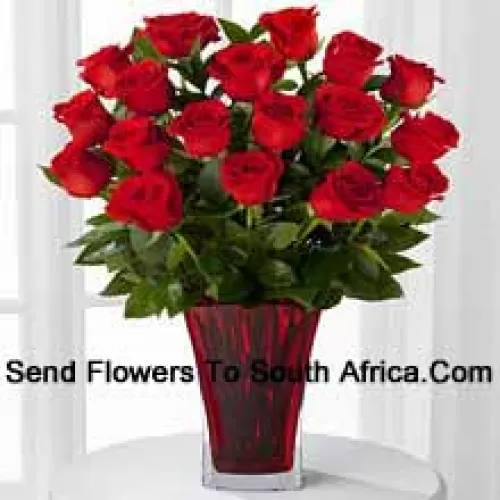 18 Red Roses With Seasonal Fillers In A Glass Vase Decorated With A Pink Bow