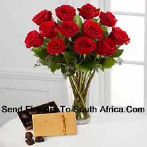 12 Red Roses With Some Ferns In A Vase And A Box Of Godiva Chocolates (We reserve the right to substitute the Godiva chocolates with chocolates of equal value in case of non-availability of the same. Limited Stock)