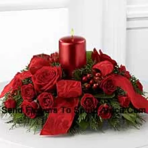 A crimson display of holiday warmth and cheer. Rich red roses and spray roses, red hypericum berries and lush holiday greens encircle a red metallic pillar candle to create a heart-warming centerpiece. Bedecked with bright red ribbon, this design will bring the spirit of the holiday season to their gatherings and celebrations with style and grace.? (Please Note That We Reserve The Right To Substitute Any Product With A Suitable Product Of Equal Value In Case Of Non-Availability Of A Certain Product)